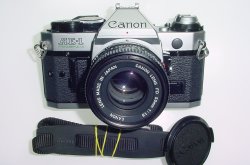 Canon AE-1 Program 35mm SLR Film Manual Camera + Canon 50mm F/1.8 FD Lens Canon AE-1 Program 35mm SLR Film Manual Camera + Canon 50mm F/1.8 FD Lens